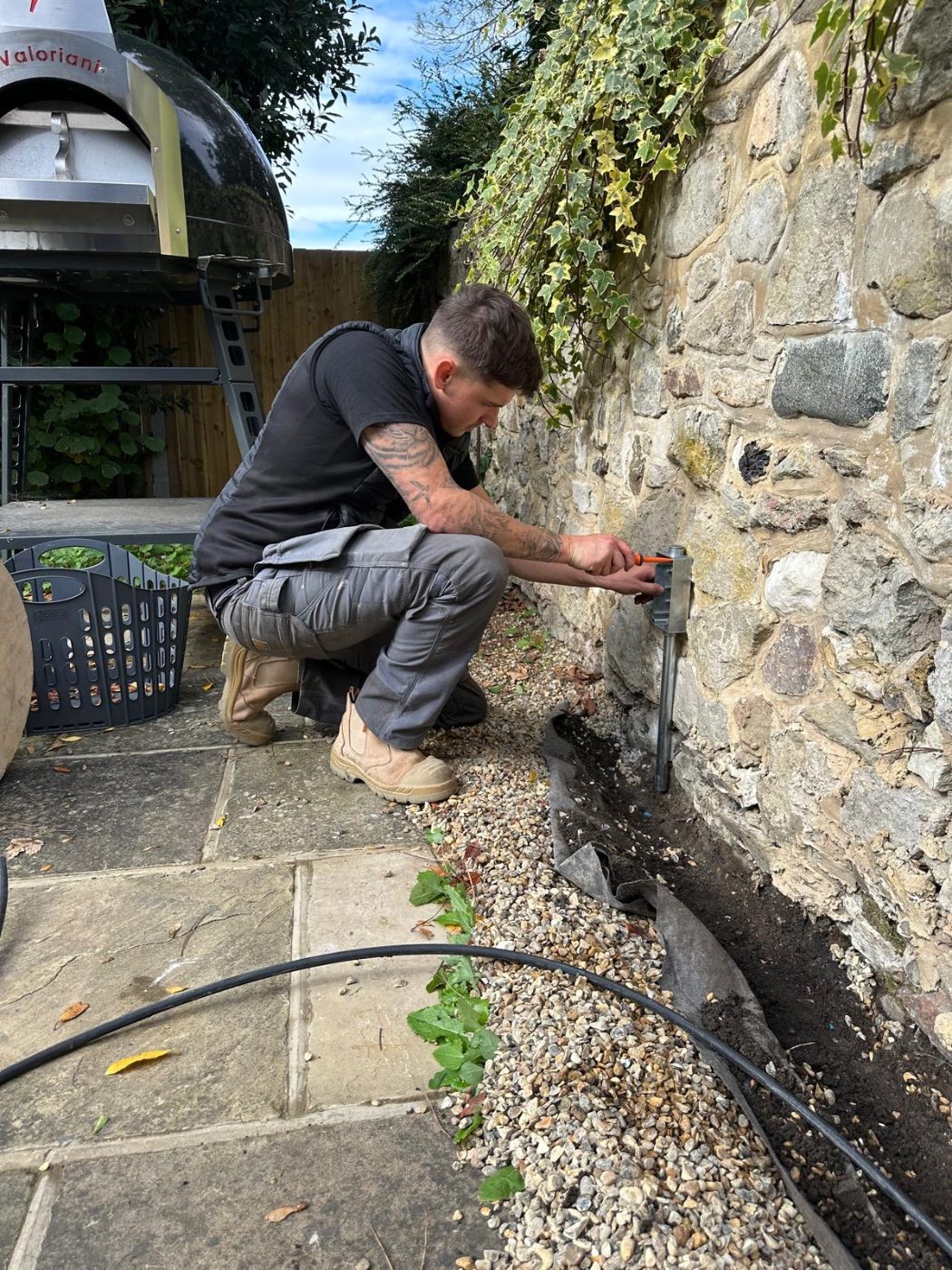 Joe Curd installing an outdoor supply