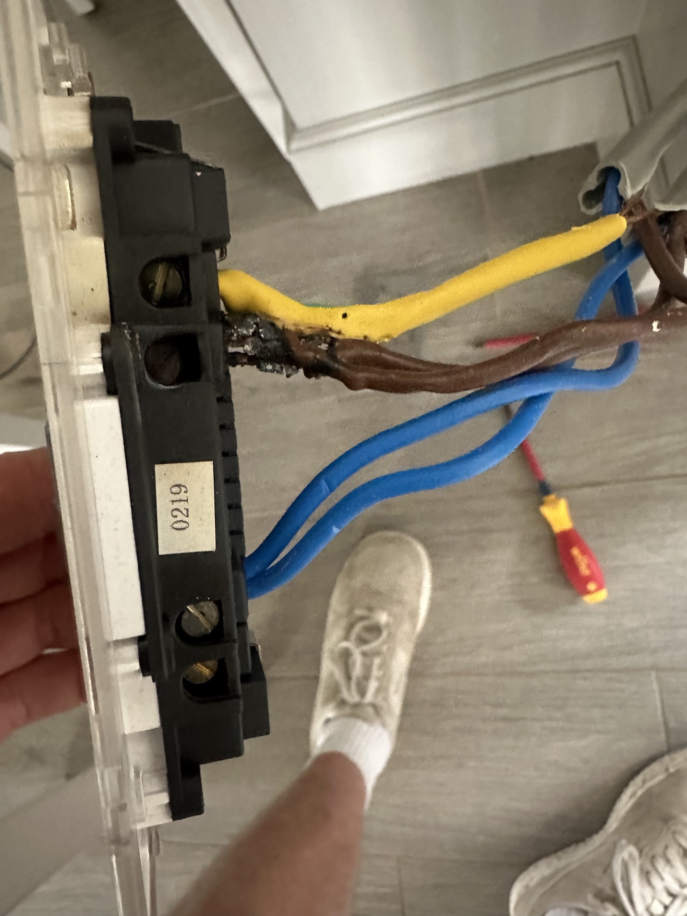 Damaged electrical wiring behind a socket