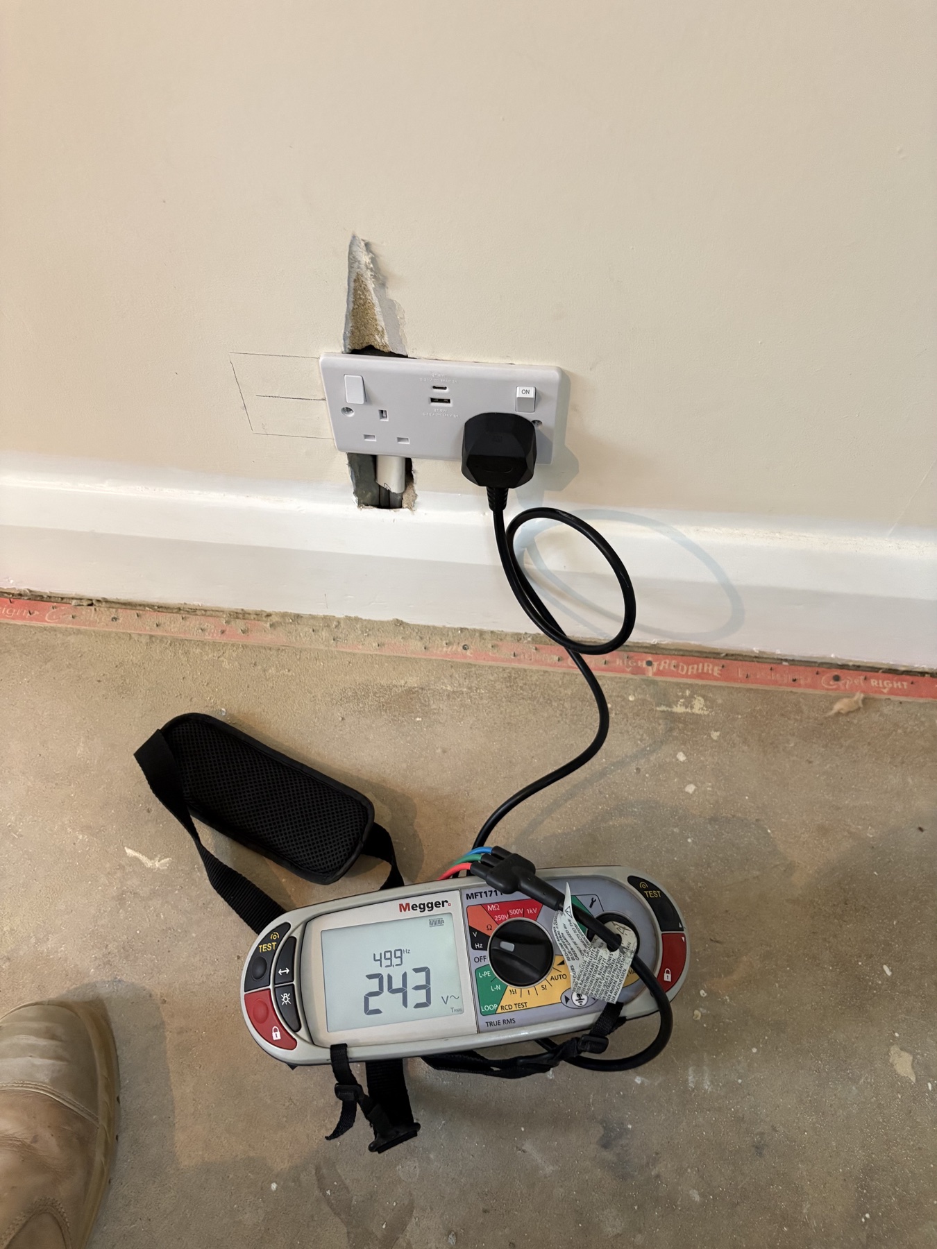 Electrical tester connected to a socket
