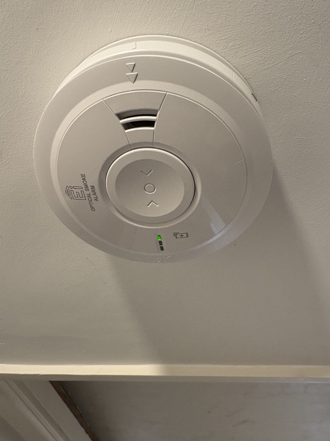 Optical smoke alarm installed on a ceiling